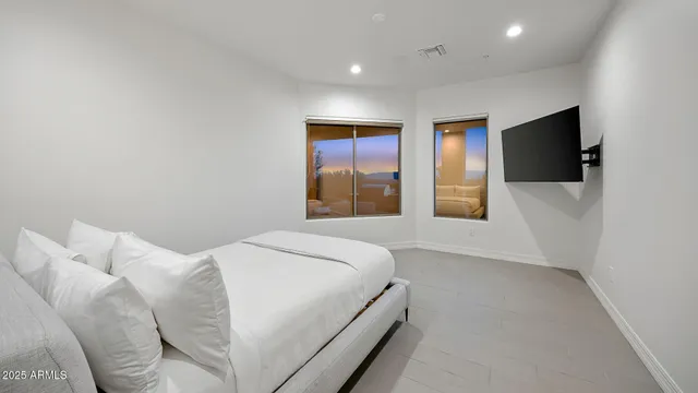 a bedroom with a bed and a flat screen tv