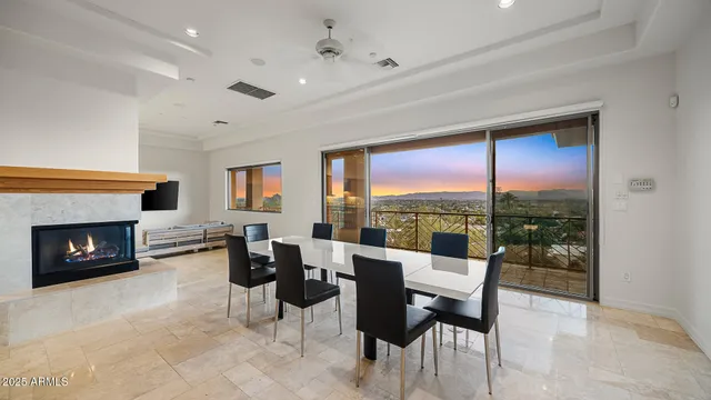a living room with furniture fireplace and floor to ceiling window