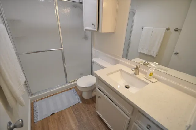 a bathroom with a sink toilet and shower