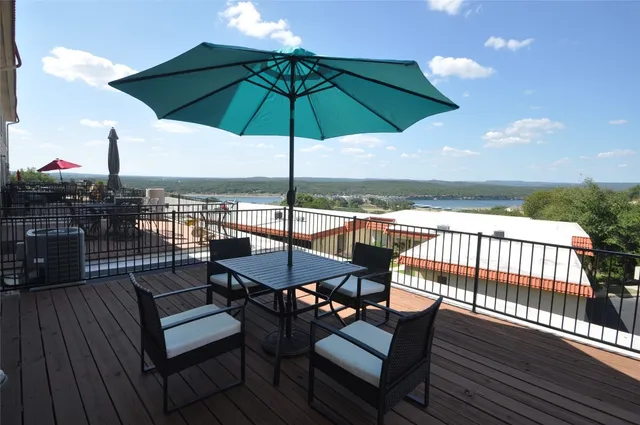 a view of a balcony with furniture and wooden floor