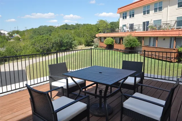 a view of a balcony with two chairs and a table