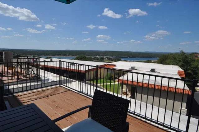 a view of a balcony with wooden floor