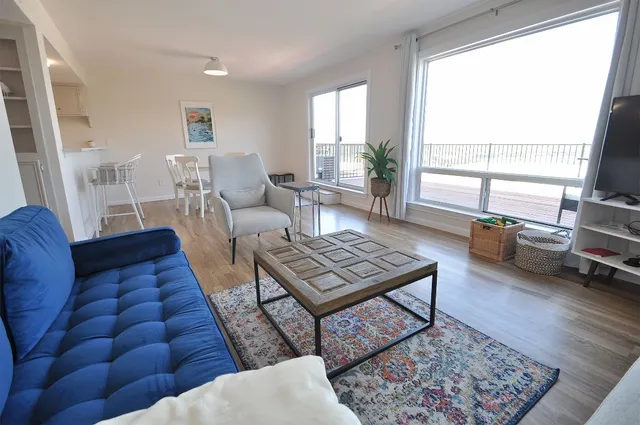 a living room with furniture rug and window