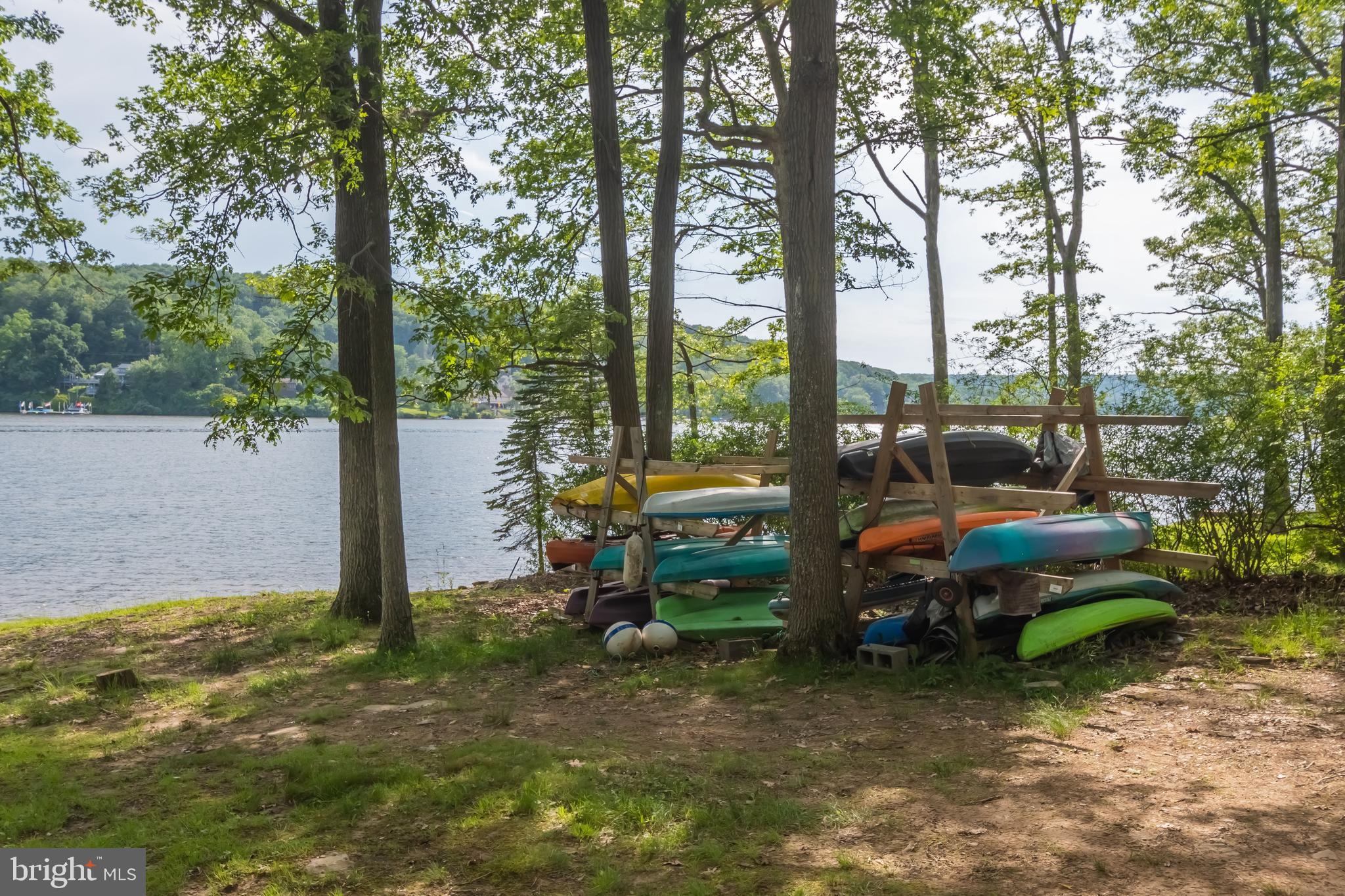 1140 Rock Lodge Road McHenry, MD 21541 - Photo 17 of 60 a backyard of a house with barbeque oven table and chairs