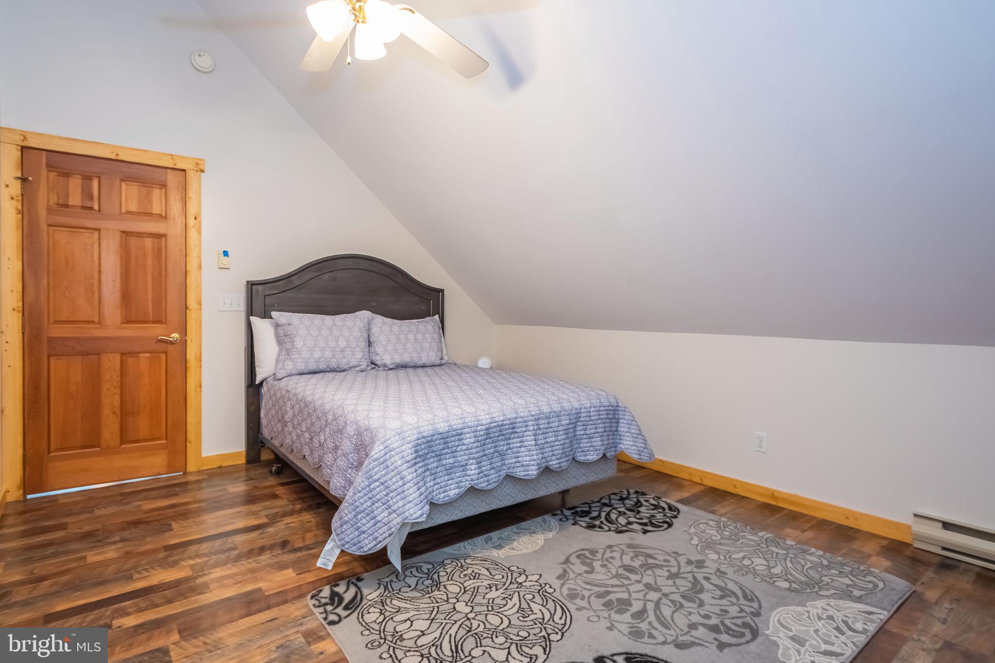 1140 Rock Lodge Road McHenry, MD 21541 - Photo 23 of 60 a bedroom with a bed and wooden floor