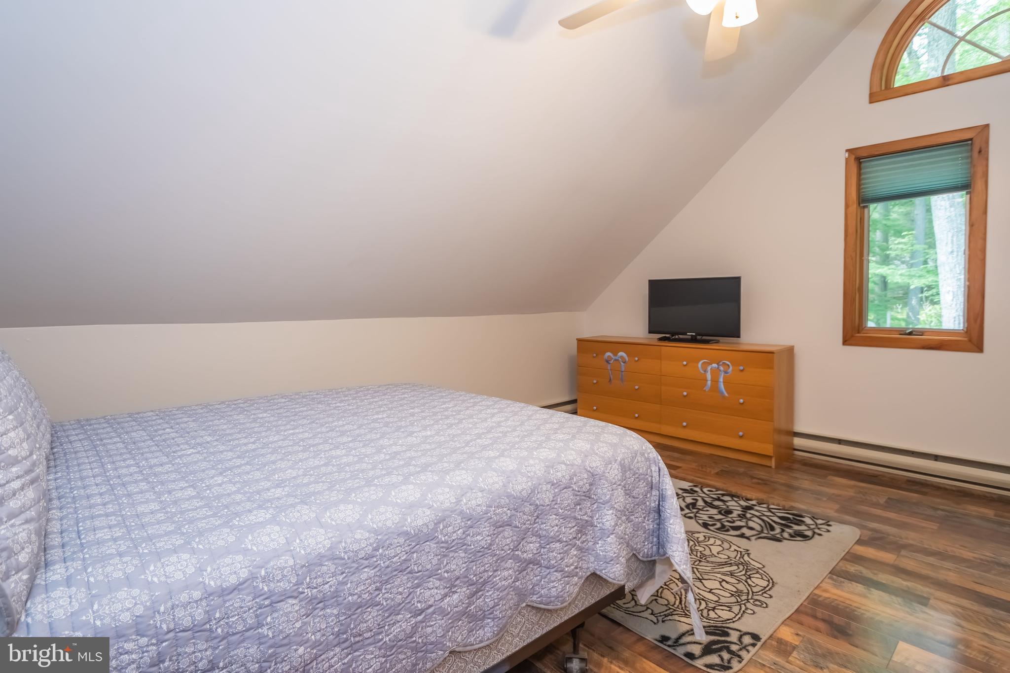 1140 Rock Lodge Road McHenry, MD 21541 - Photo 24 of 60 a bed room with a bed and a television