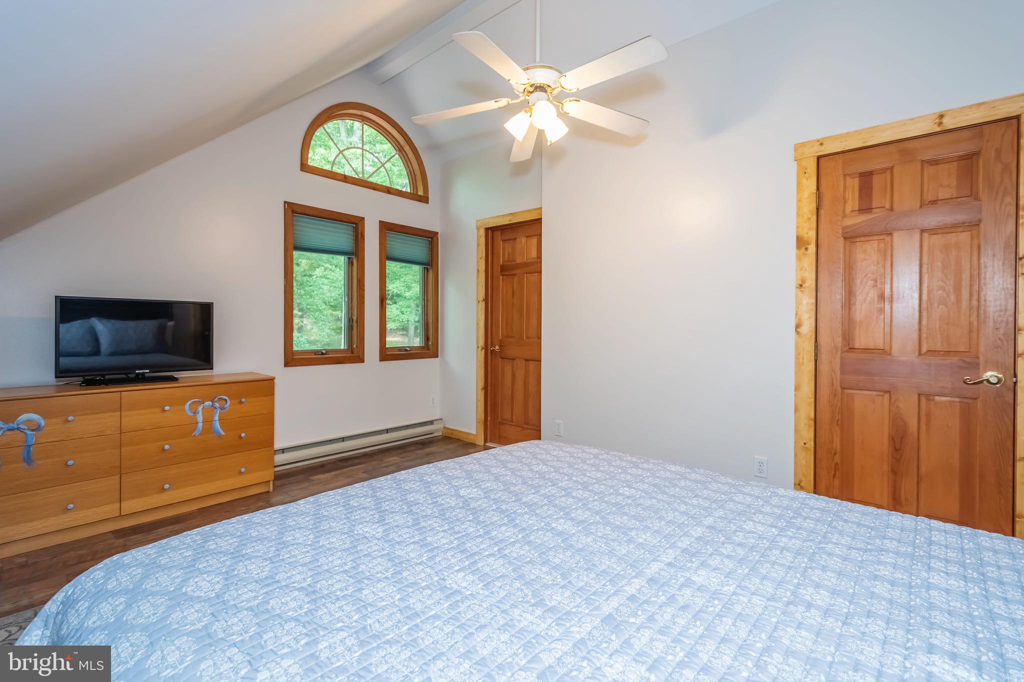 1140 Rock Lodge Road McHenry, MD 21541 - Photo 25 of 60 a bedroom with a bed and a flat screen tv