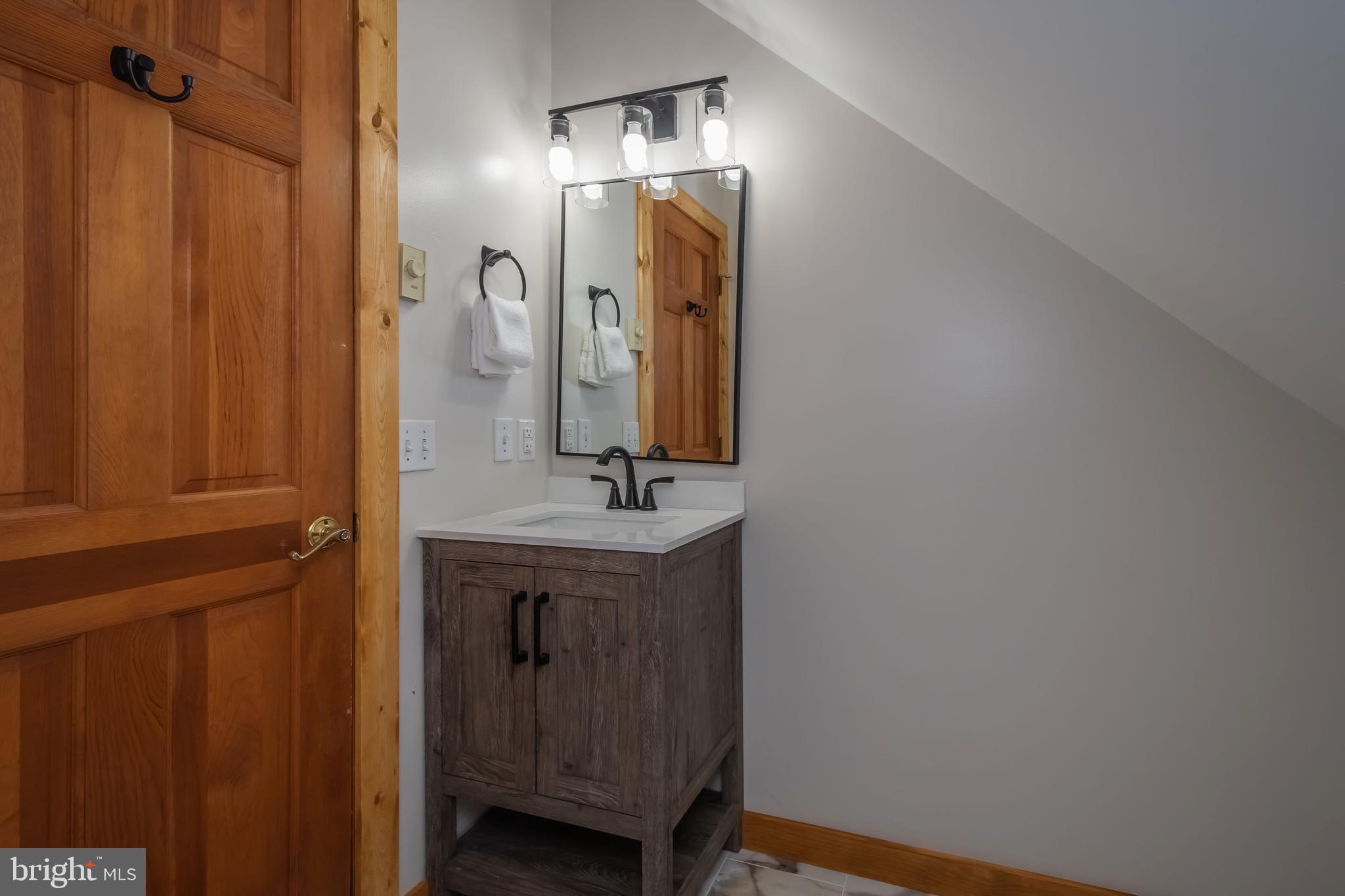 1140 Rock Lodge Road McHenry, MD 21541 - Photo 26 of 60 a bathroom with a sink and a mirror