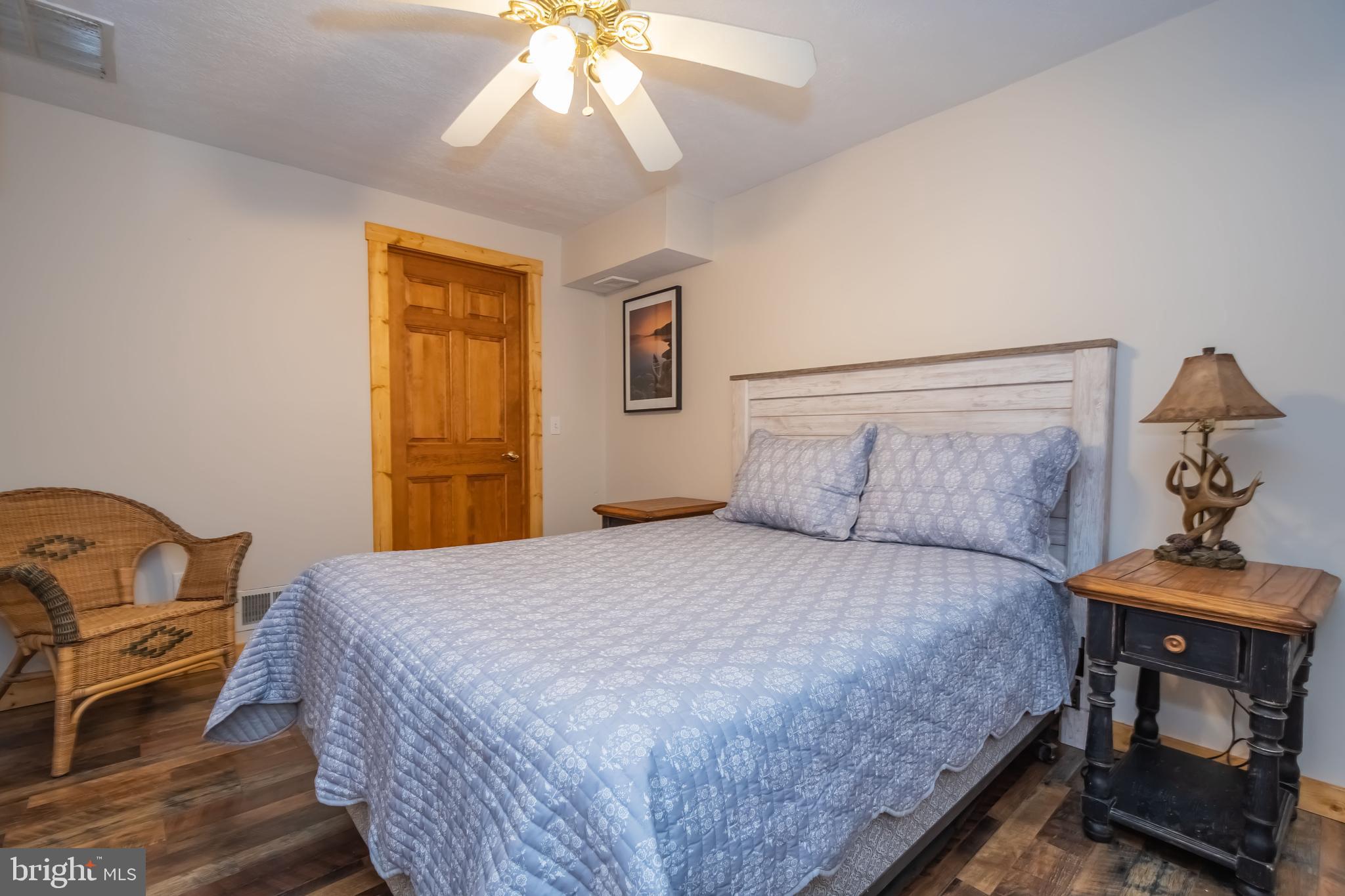 1140 Rock Lodge Road McHenry, MD 21541 - Photo 32 of 60 a bedroom with a bed and a chandelier