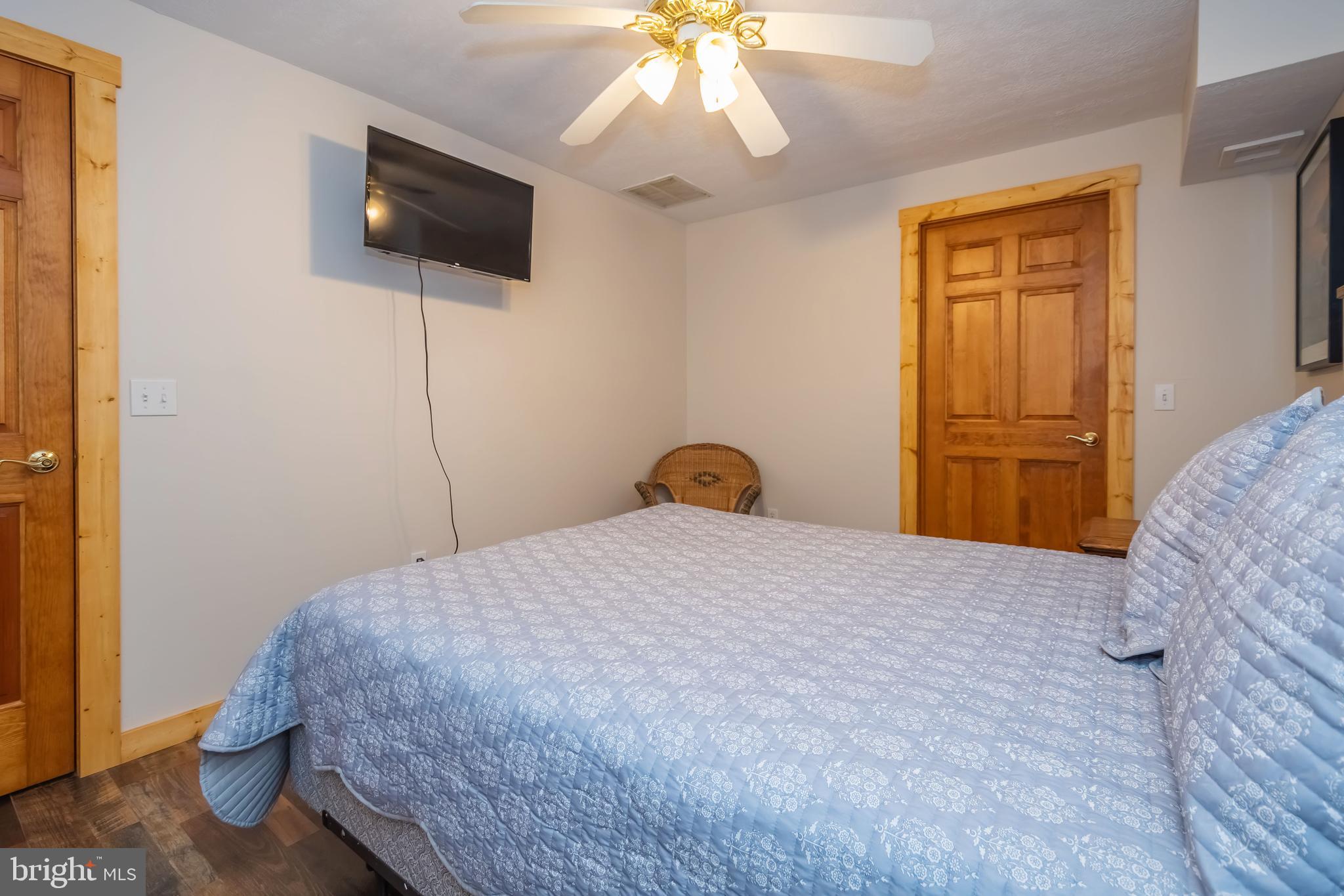 1140 Rock Lodge Road McHenry, MD 21541 - Photo 33 of 60 a bedroom with a bed and a flat screen tv