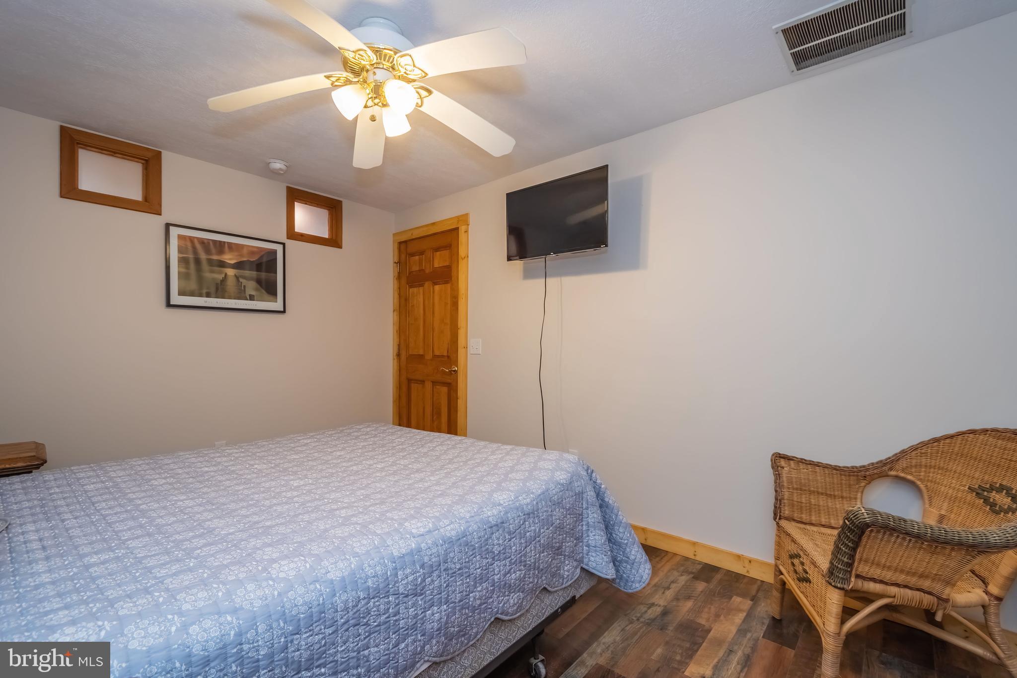 1140 Rock Lodge Road McHenry, MD 21541 - Photo 34 of 60 a bedroom with a bed and a flat screen tv