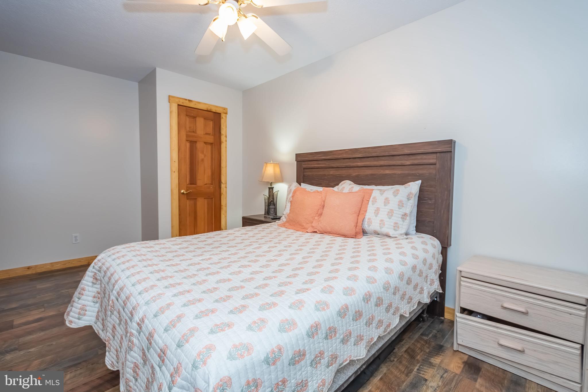 1140 Rock Lodge Road McHenry, MD 21541 - Photo 42 of 60 a bedroom with a bed and a chandelier