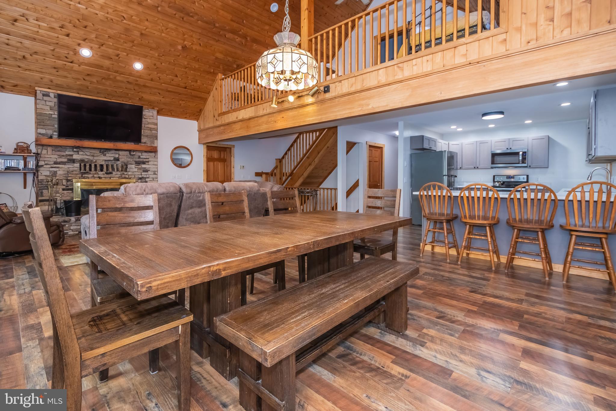 1140 Rock Lodge Road McHenry, MD 21541 - Photo 46 of 60 a view of a dining room with furniture wooden floor and chandelier