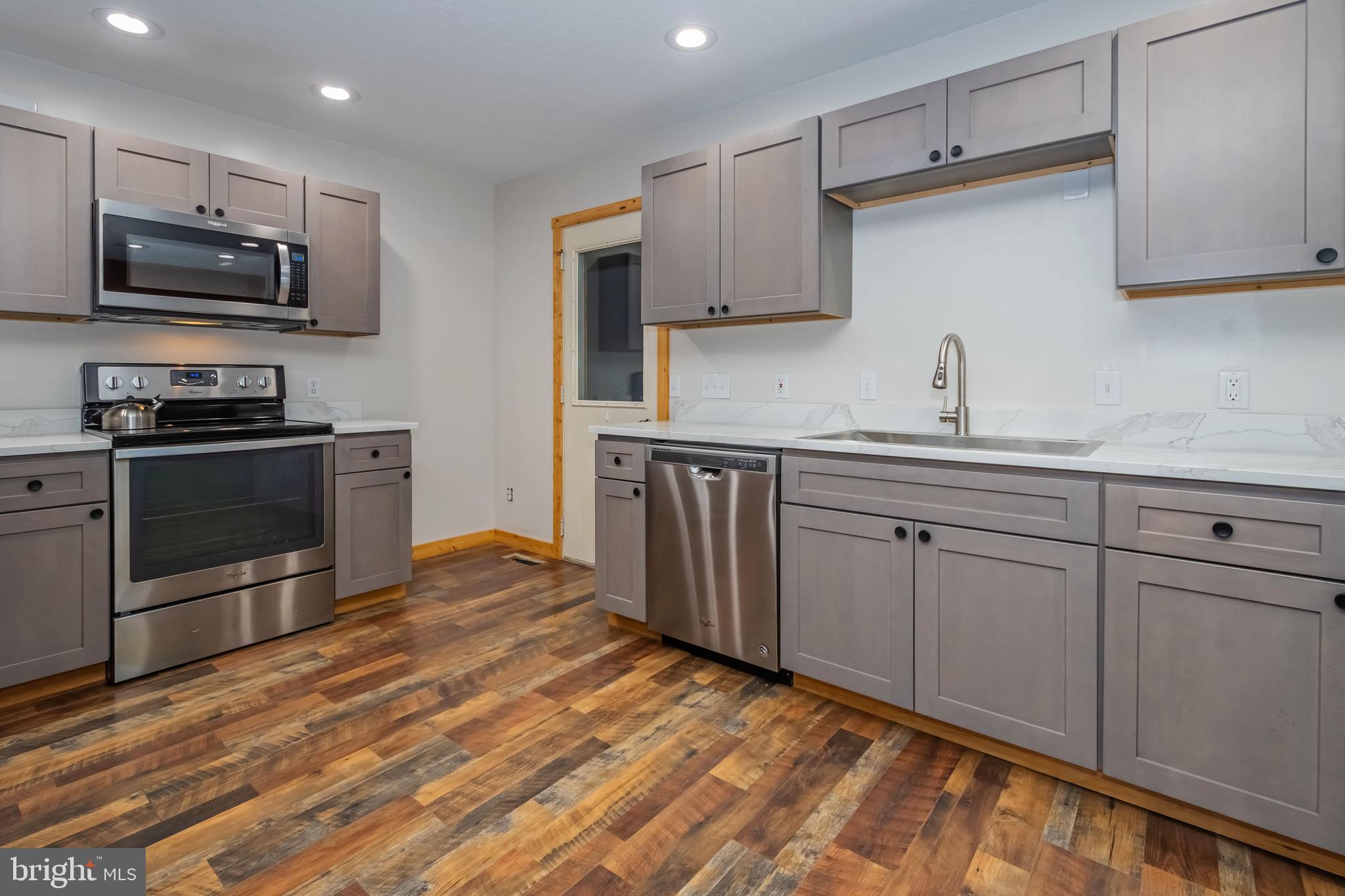 1140 Rock Lodge Road McHenry, MD 21541 - Photo 50 of 60 a kitchen with stainless steel appliances granite countertop a sink stove and microwave