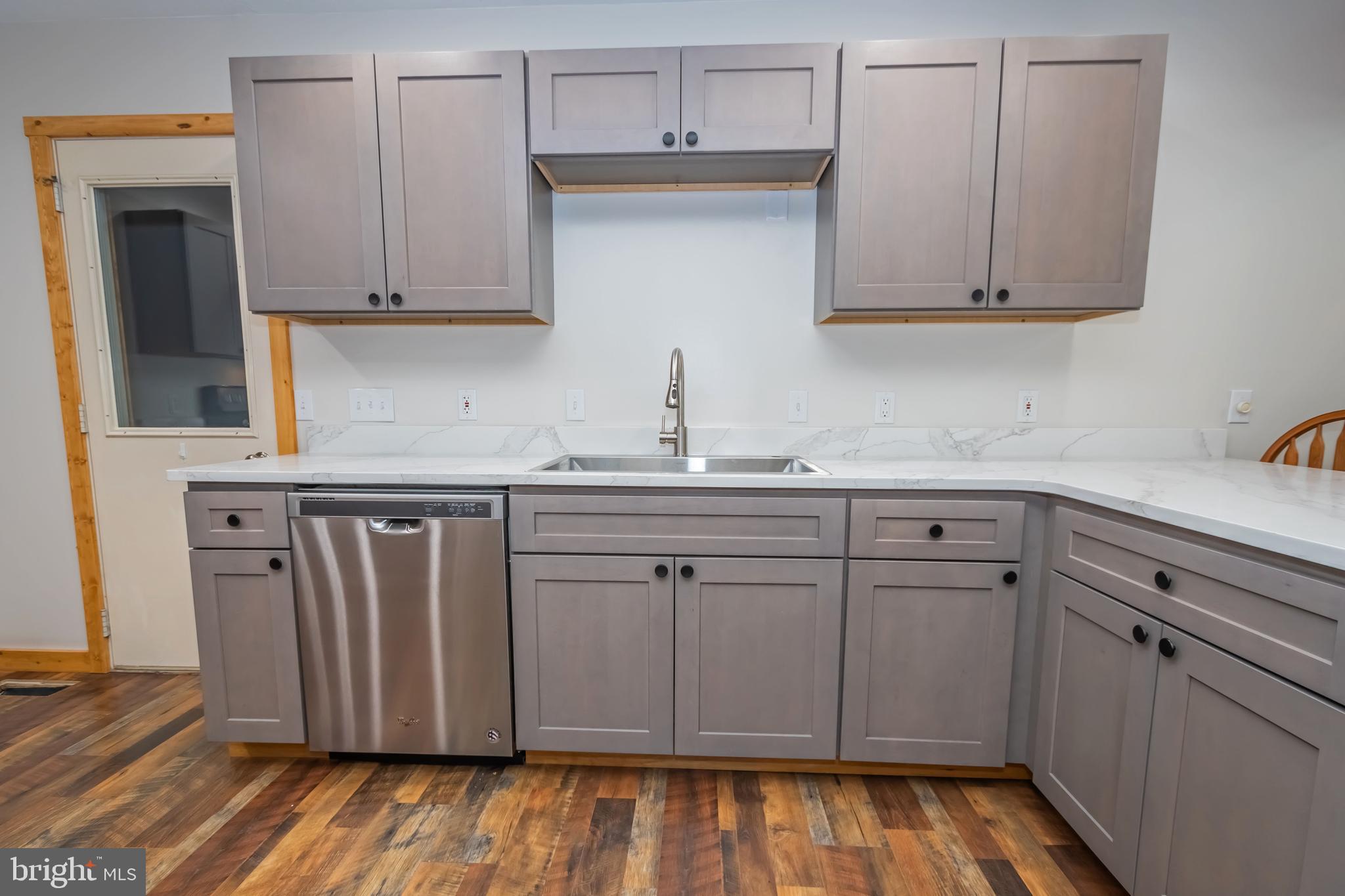 1140 Rock Lodge Road McHenry, MD 21541 - Photo 5 of 60 a kitchen with stainless steel appliances granite countertop a sink and cabinets with wooden floor
