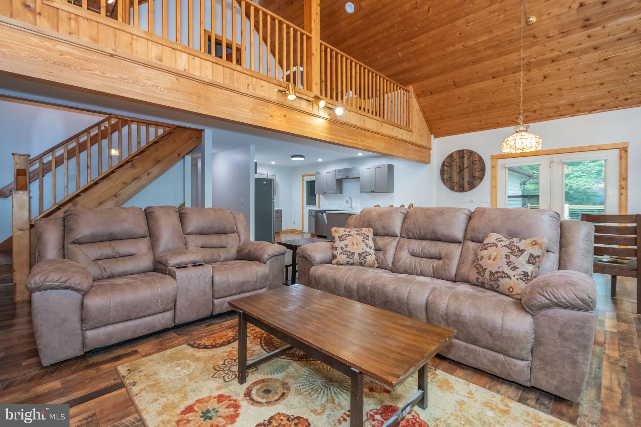 1140 Rock Lodge Road McHenry, MD 21541 - Photo 53 of 60 a living room with furniture a clock and a rug