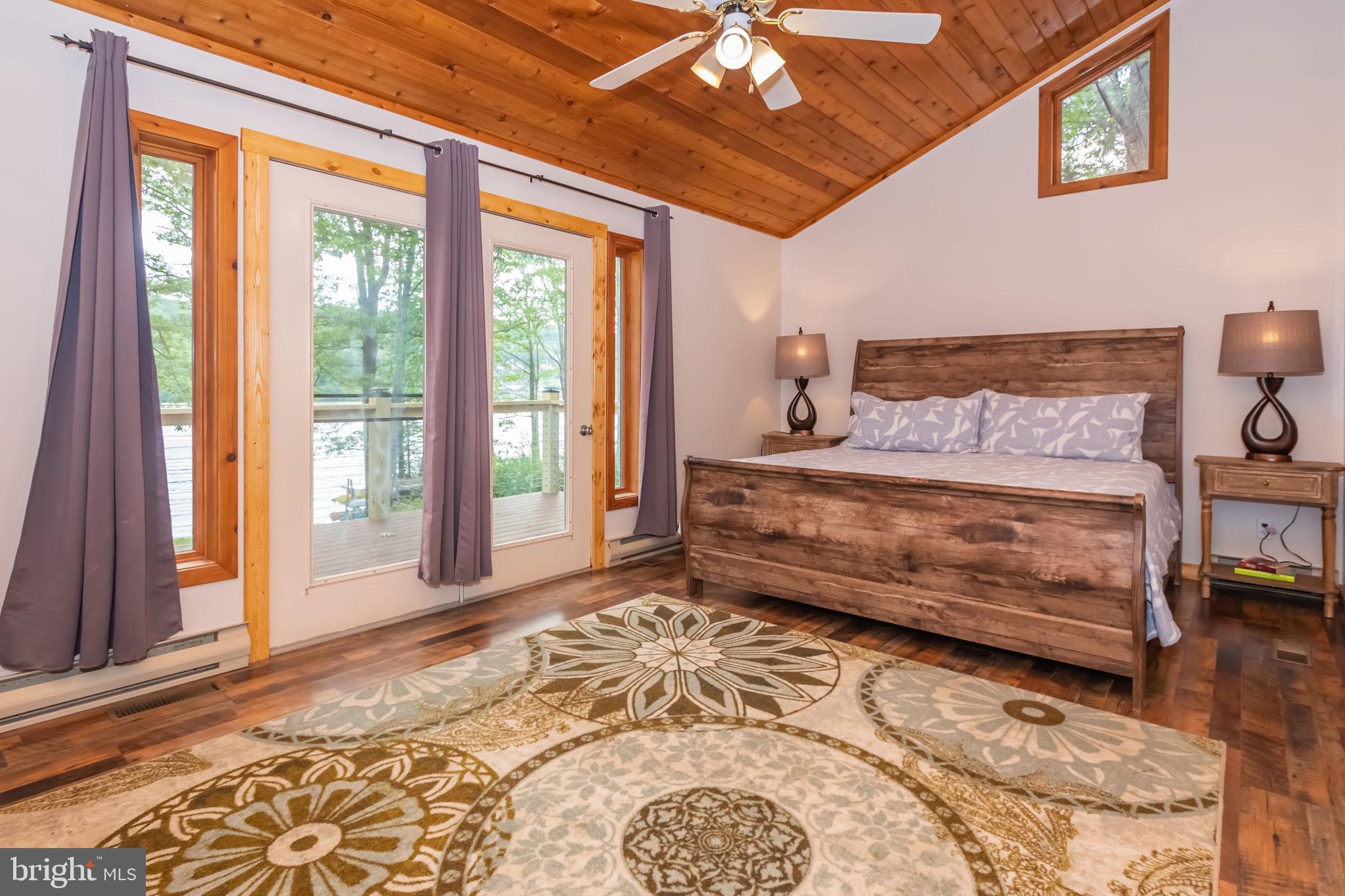 1140 Rock Lodge Road McHenry, MD 21541 - Photo 55 of 60 a bedroom with a large bed and a window