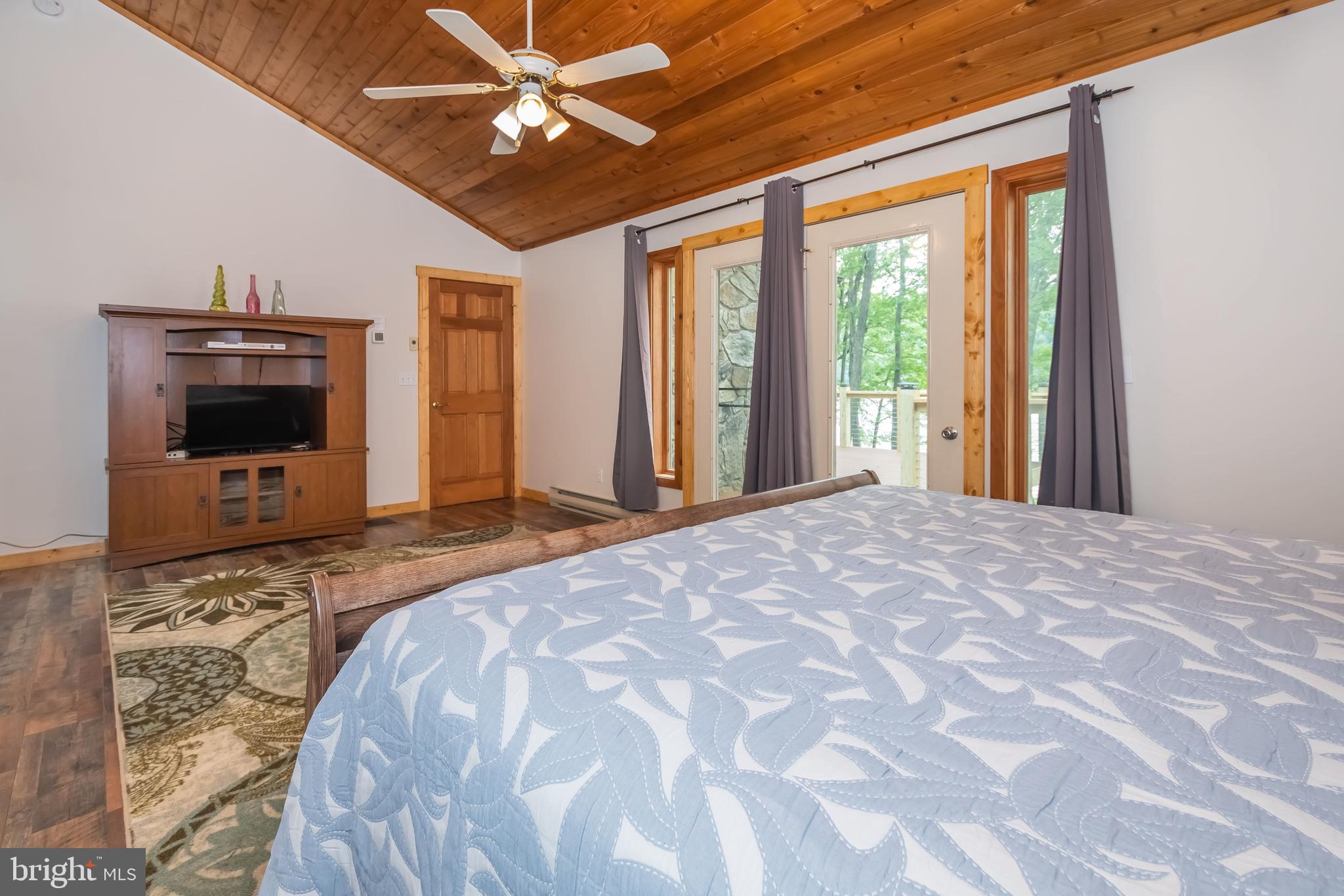 1140 Rock Lodge Road McHenry, MD 21541 - Photo 56 of 60 a bedroom with a bed and a flat screen tv