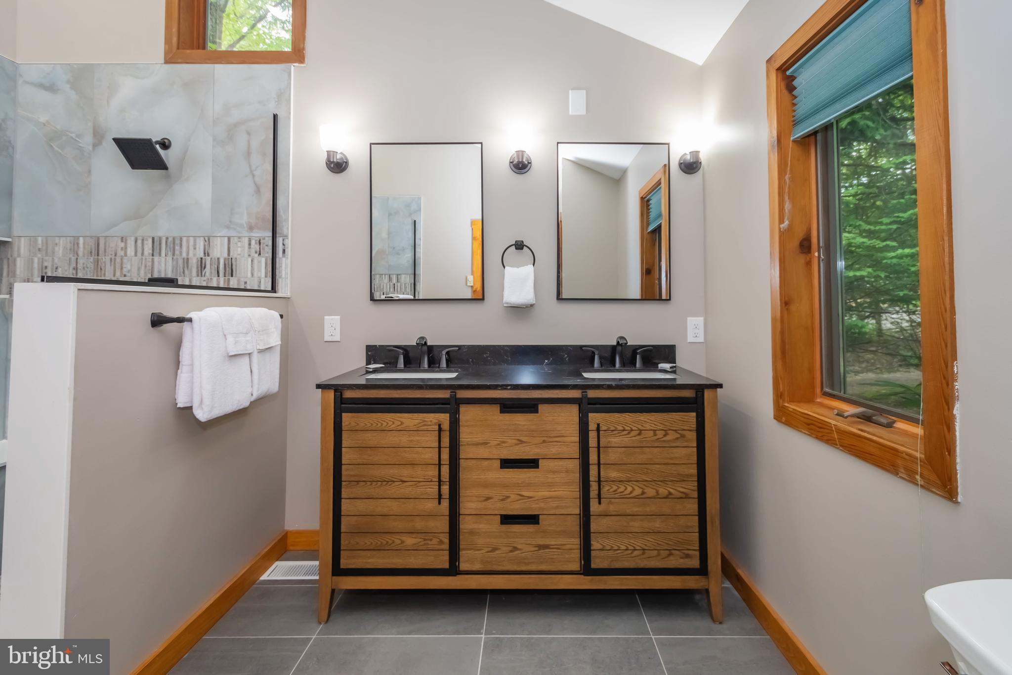 1140 Rock Lodge Road McHenry, MD 21541 - Photo 58 of 60 a bathroom with a granite countertop sink and a mirror