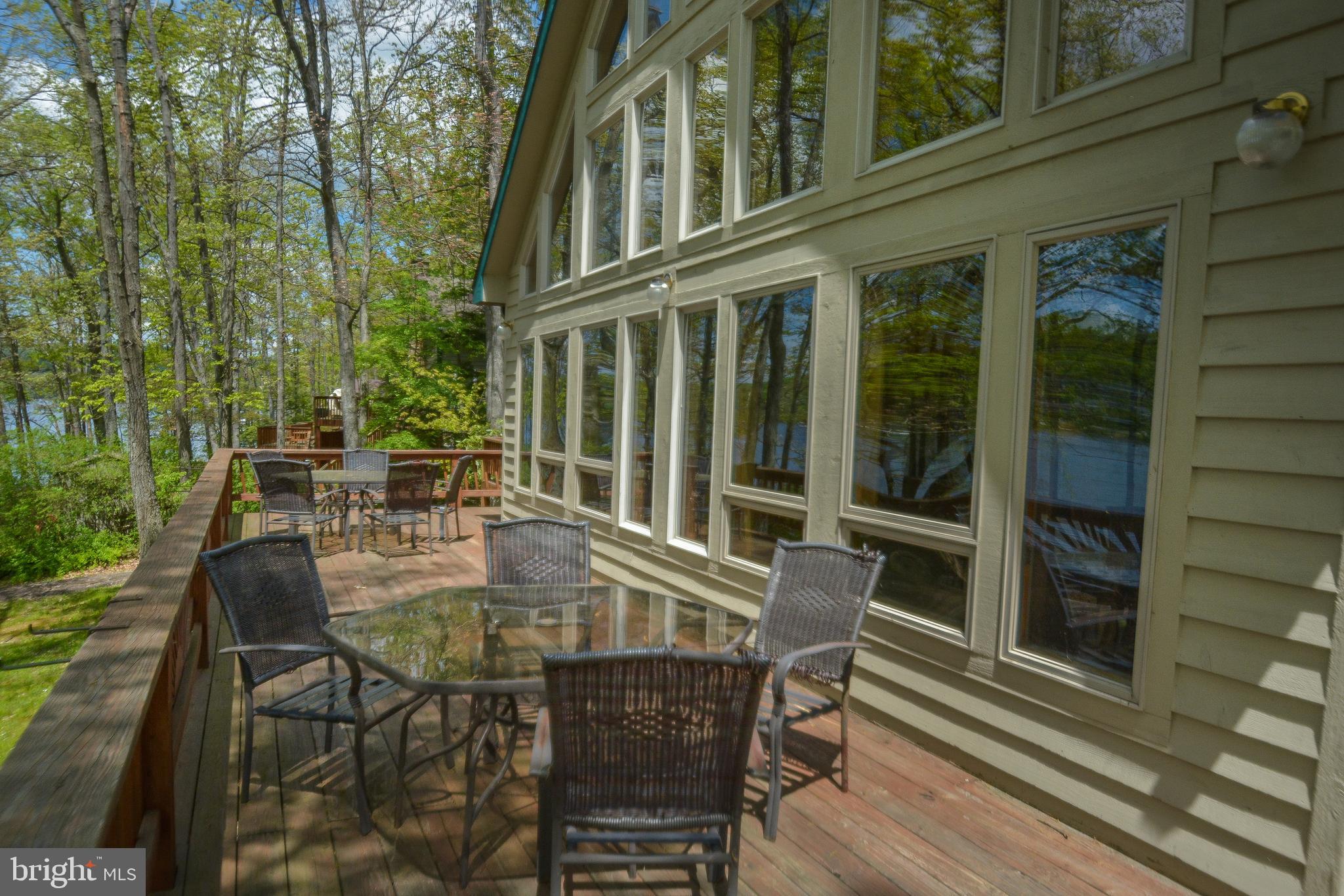 1140 Rock Lodge Road McHenry, MD 21541 - Photo 9 of 60 front view of a house with a chairs and table in the balcony