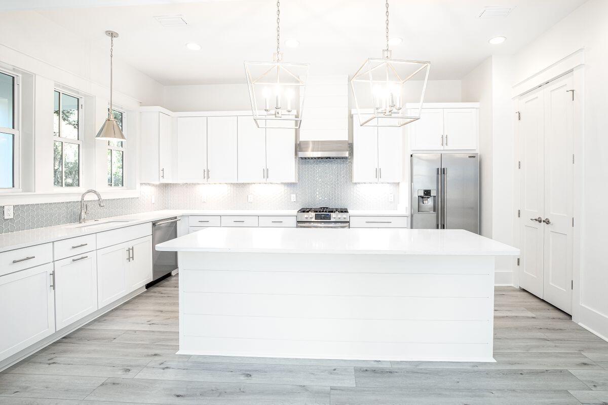 274 Redbud Ln Inlet Beach Inlet Beach, FL 32461 - Photo 2 of 25 a large white kitchen with wooden floor