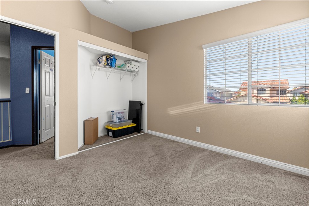 15417 Tobarra Road Fontana, CA 92337 - Photo 20 of 29 an empty room with furniture and a window