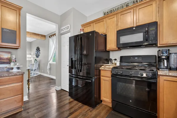 a kitchen with stainless steel appliances granite countertop a stove a refrigerator and a microwave