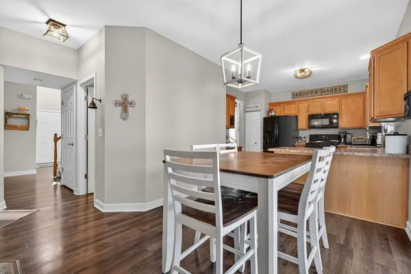a view of a dining room with furniture wooden floor and chandelier