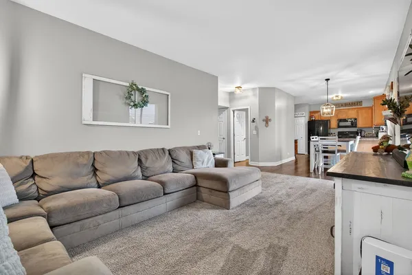 a living room with furniture and a kitchen view