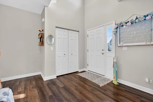 an empty room with wooden floor and cabinet