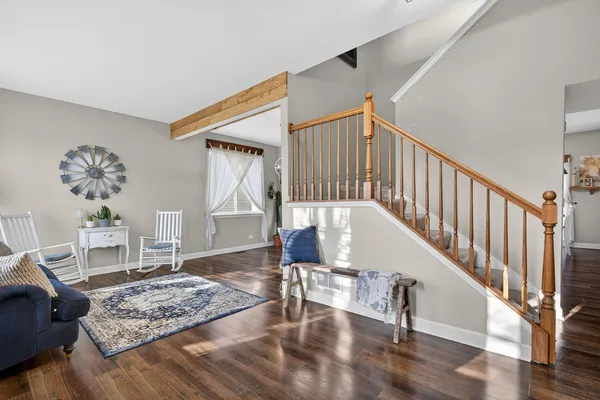 a view of entryway and hall with wooden floor