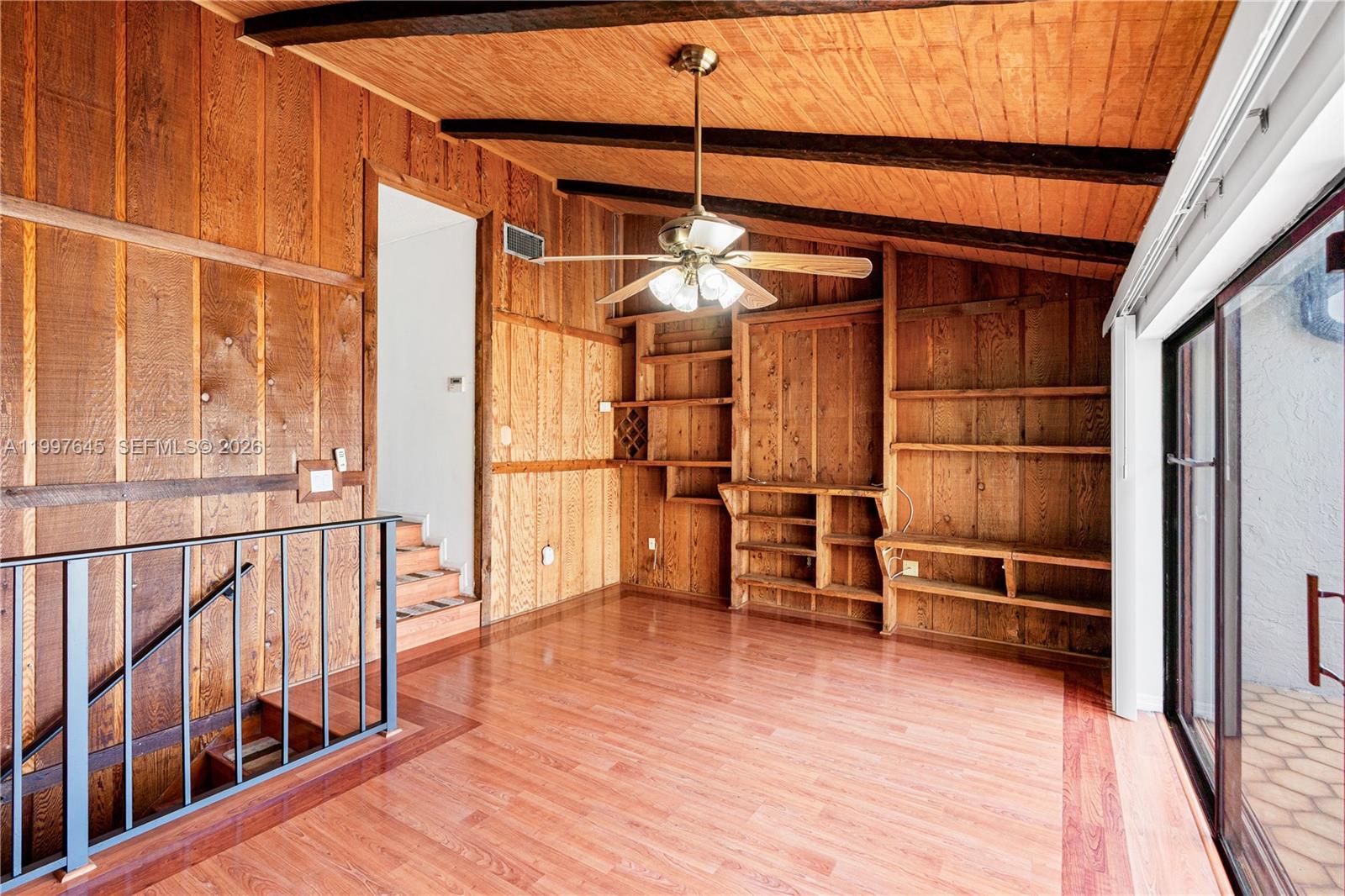 8748 Southwest 154th Cir Place, Unit 6N Miami, FL 33193 - Photo 15 of 34 a view of empty room with wooden floor and windows
