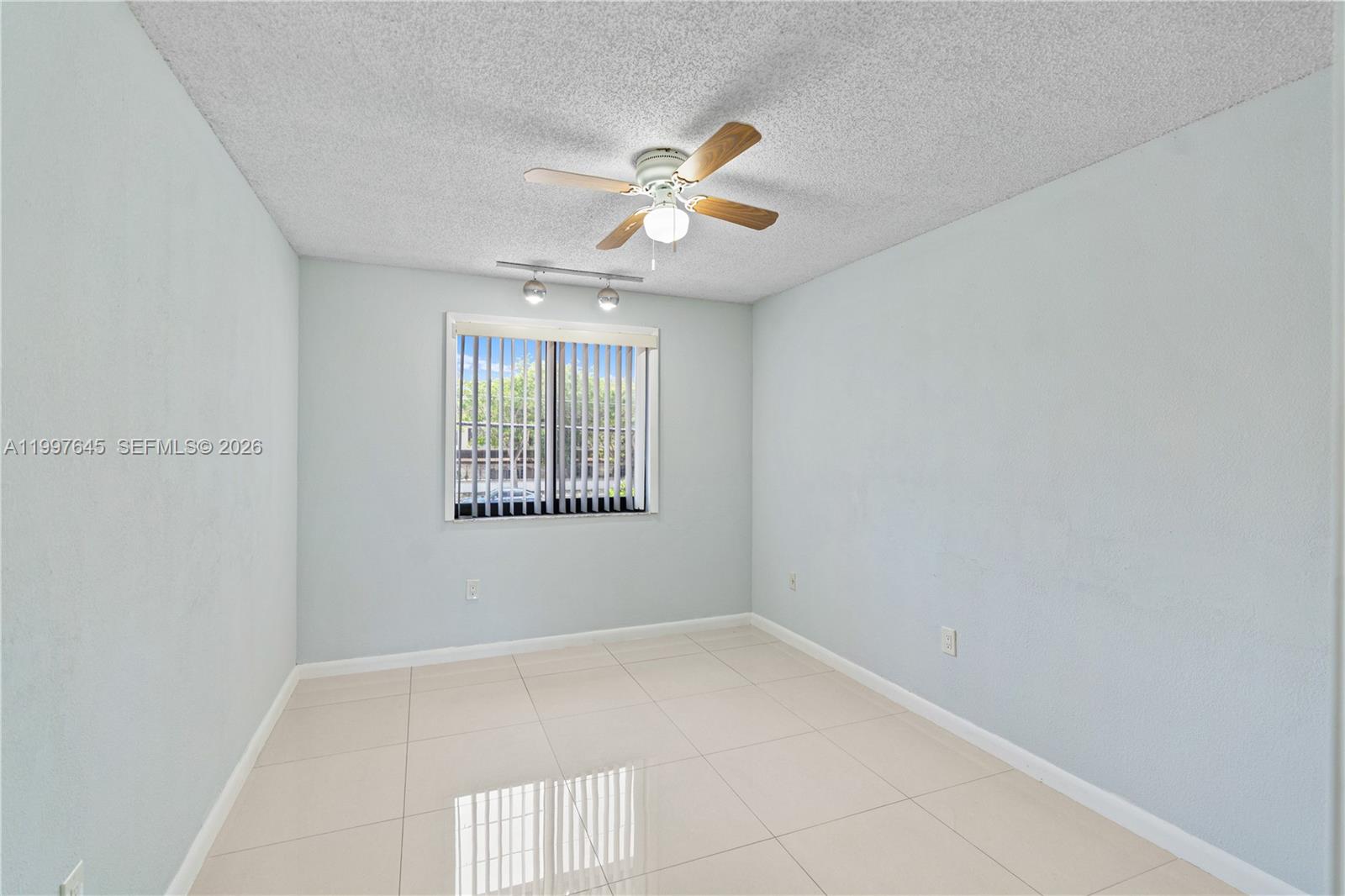 8748 Southwest 154th Cir Place, Unit 6N Miami, FL 33193 - Photo 23 of 34 an empty room with windows and fan