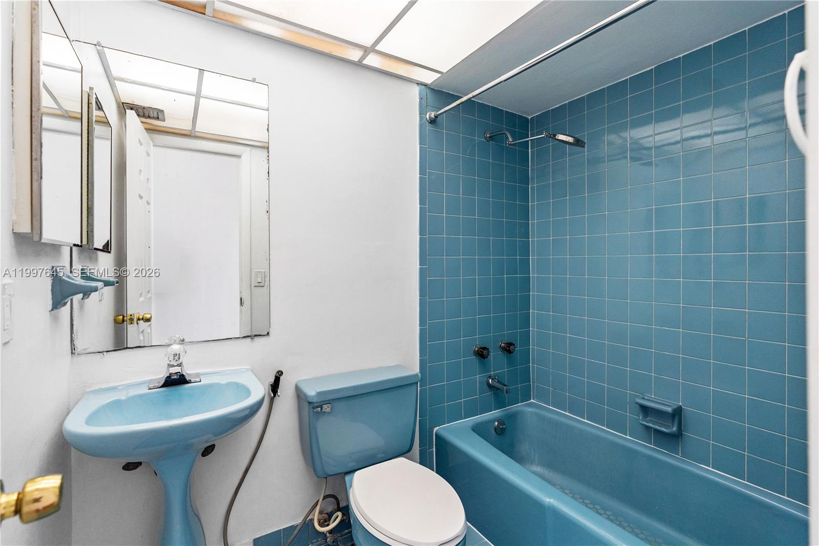 8748 Southwest 154th Cir Place, Unit 6N Miami, FL 33193 - Photo 25 of 34 a bathroom with a sink toilet and shower