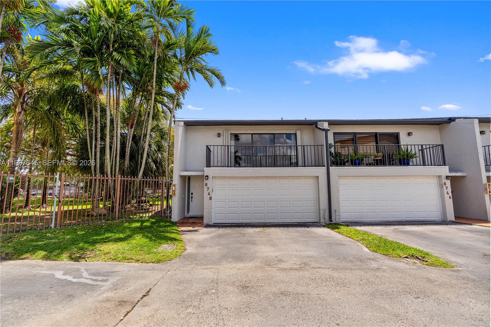 8748 Southwest 154th Cir Place, Unit 6N Miami, FL 33193 - Photo 3 of 34 a front view of a house with a garden