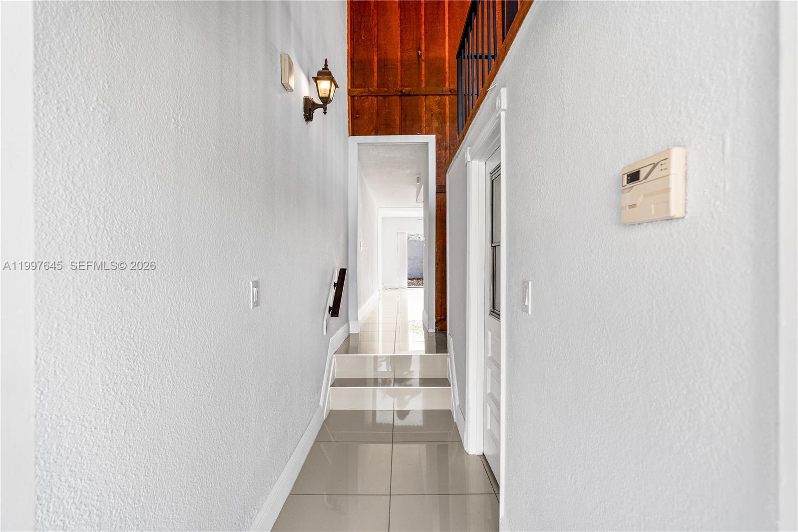 8748 Southwest 154th Cir Place, Unit 6N Miami, FL 33193 - Photo 5 of 34 a view of a hallway with staircase