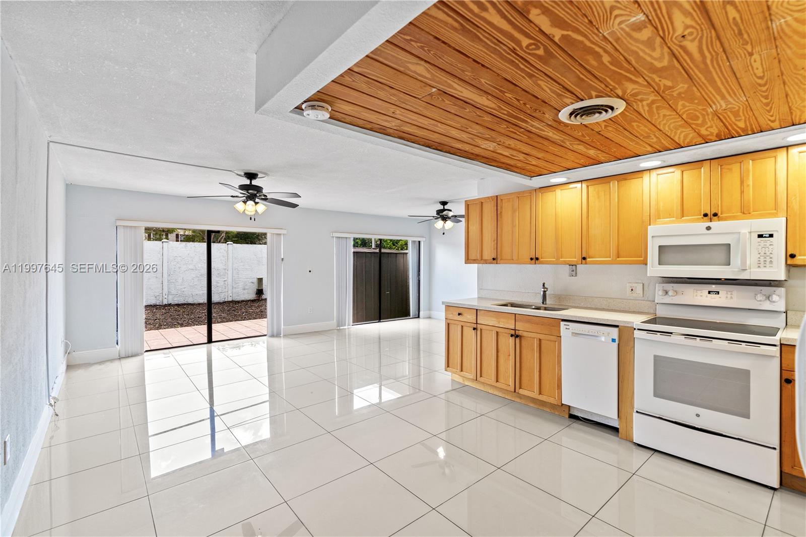 8748 Southwest 154th Cir Place, Unit 6N Miami, FL 33193 - Photo 6 of 34 a kitchen with stainless steel appliances granite countertop a stove a sink and dishwasher