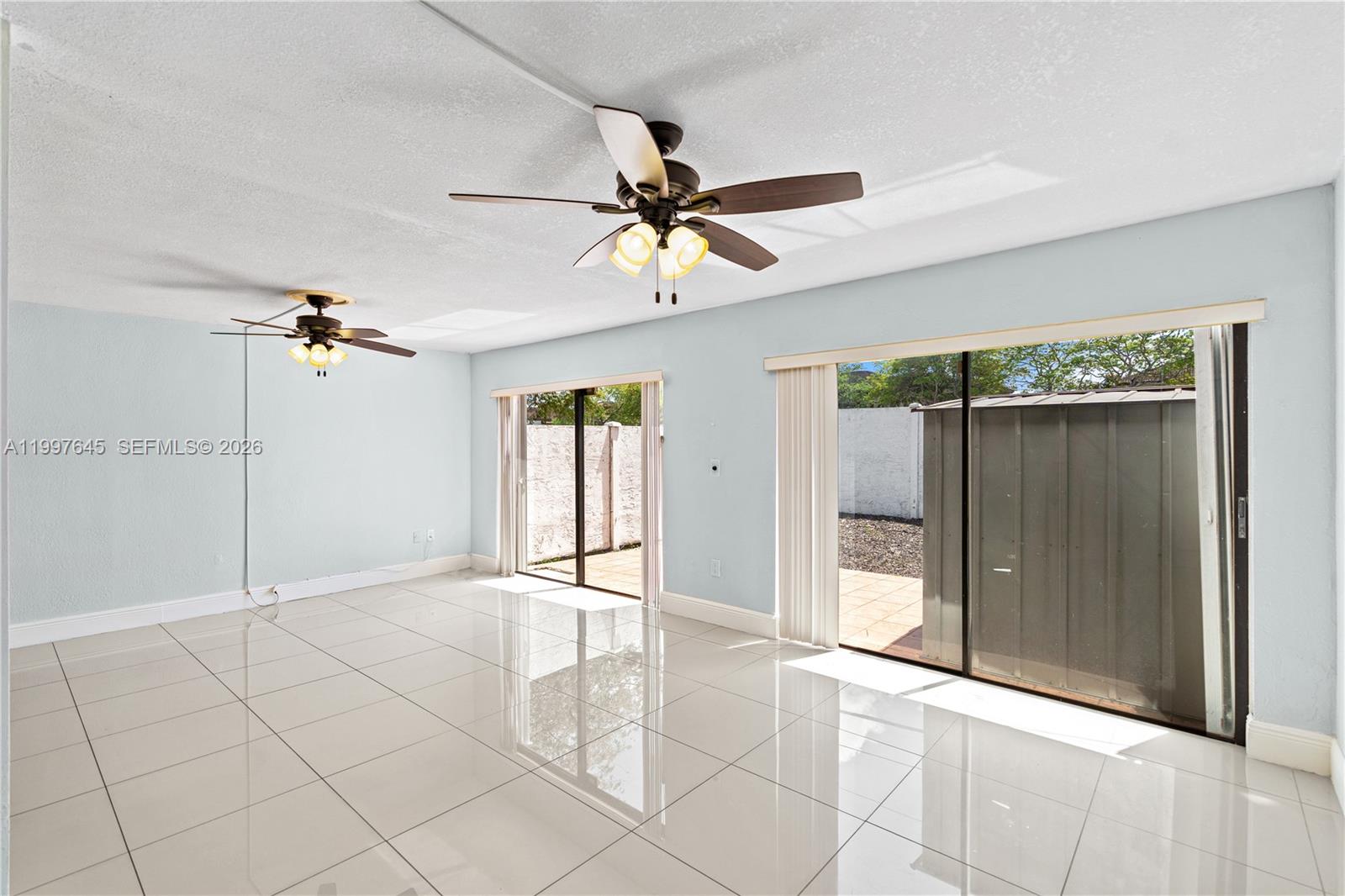8748 Southwest 154th Cir Place, Unit 6N Miami, FL 33193 - Photo 10 of 34 wooden floor in an empty room with a window