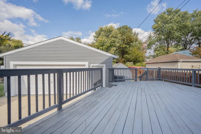 a balcony with wooden floor and fence