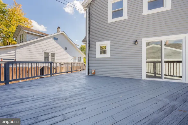 a view of a house with wooden deck