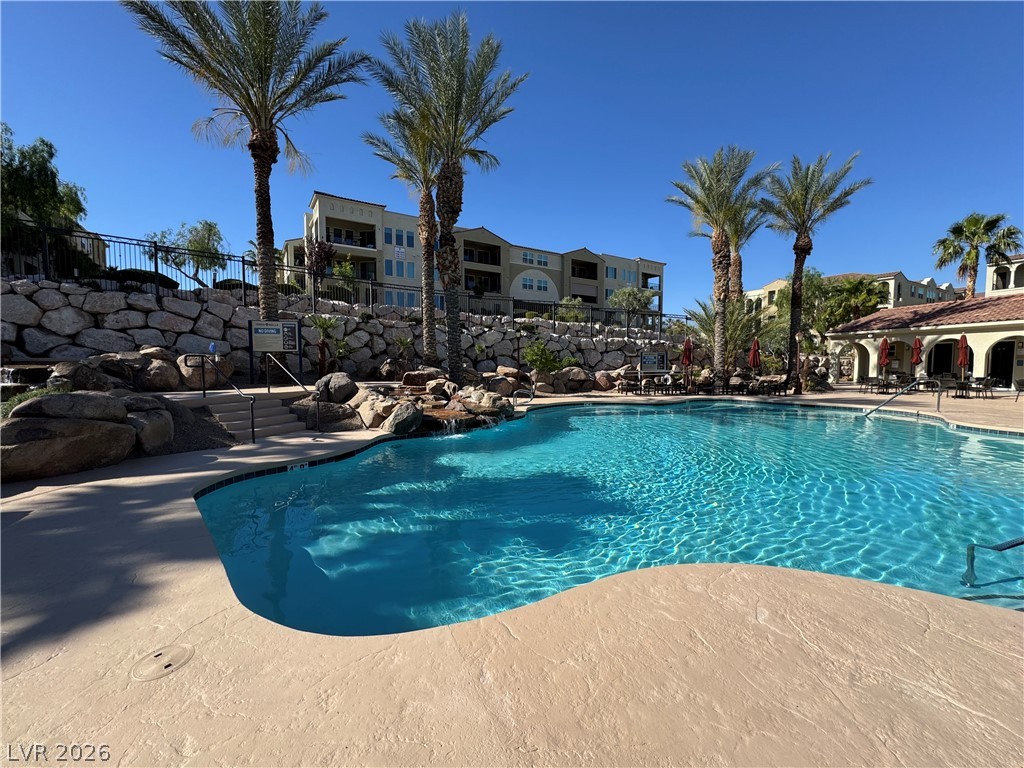 2555 Hampton Road, Unit 4205 Henderson, NV 89052 - Photo 51 of 52 Relax poolside at this inviting community oasis, featuring crystal-clear waters and lush surroundings.