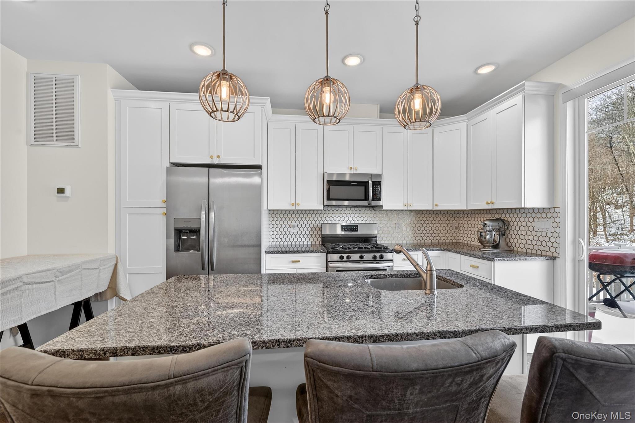 76 Magnolia Park Road Middletown, NY 10940 - Photo 12 of 39 a kitchen with stainless steel appliances granite countertop a sink a center island a stove and a window