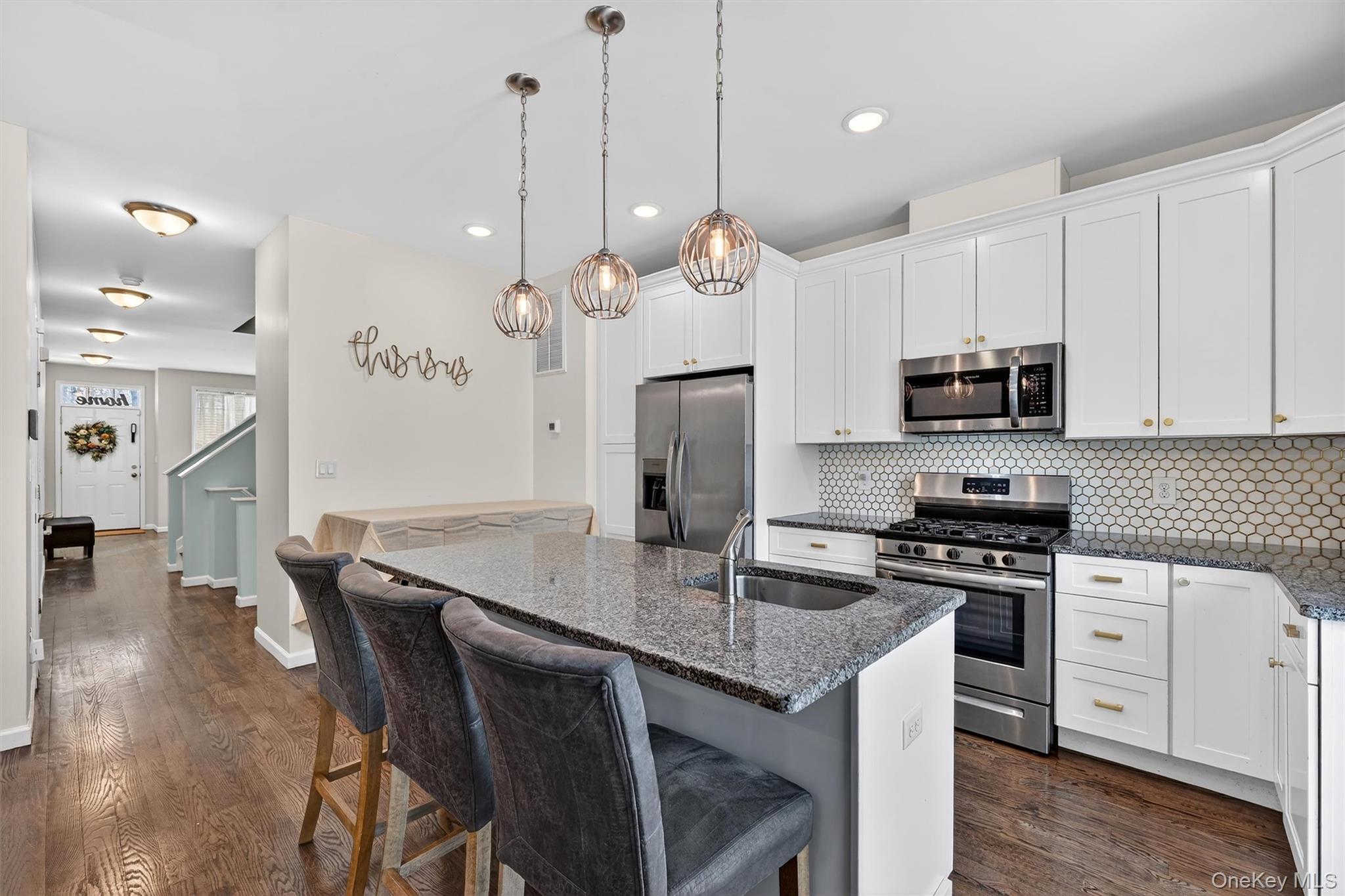 76 Magnolia Park Road Middletown, NY 10940 - Photo 13 of 39 a kitchen with stainless steel appliances granite countertop a stove a refrigerator a kitchen island a sink a dining table and chairs