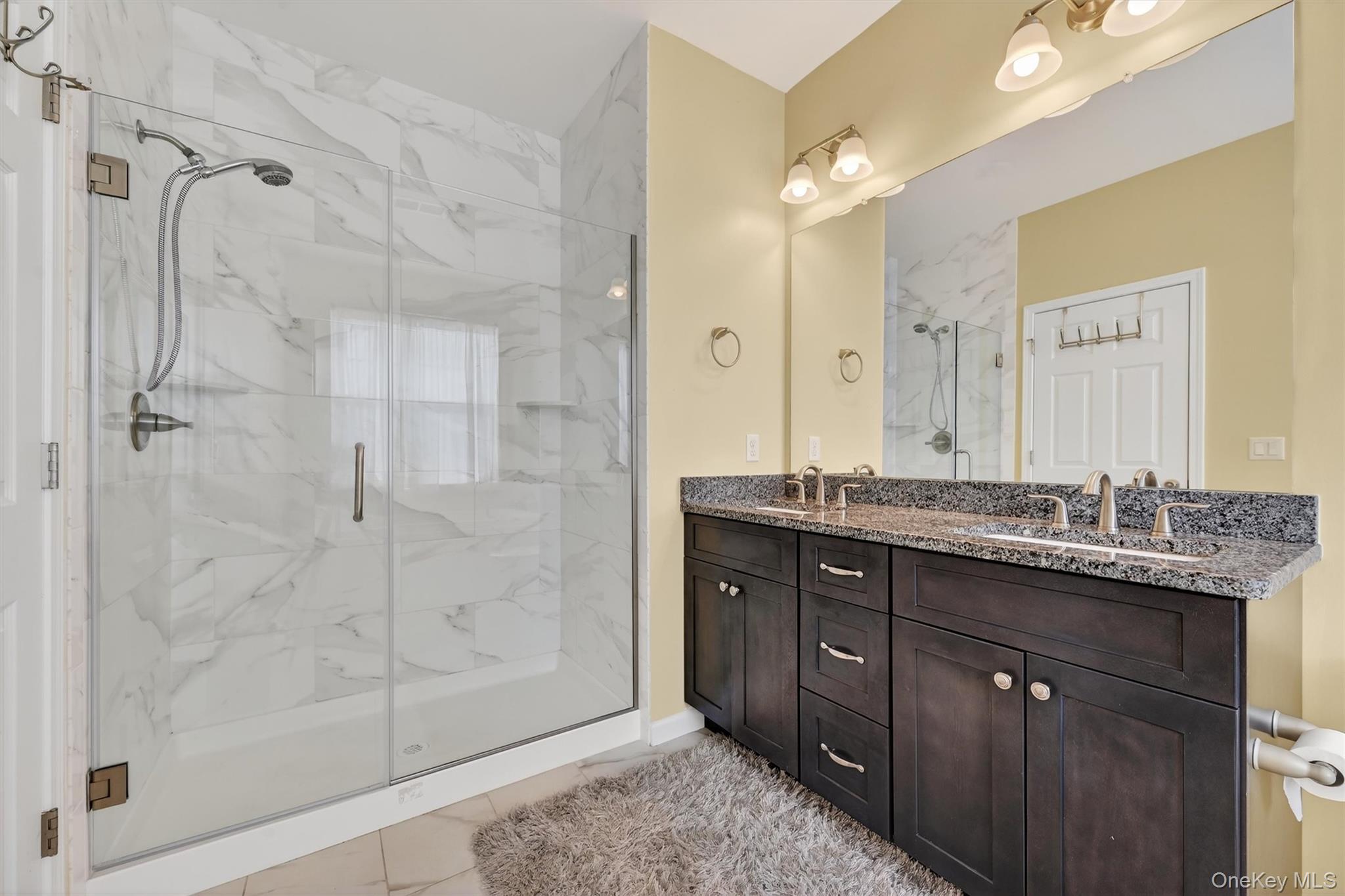 76 Magnolia Park Road Middletown, NY 10940 - Photo 22 of 39 a bathroom with a granite countertop sink a mirror and shower