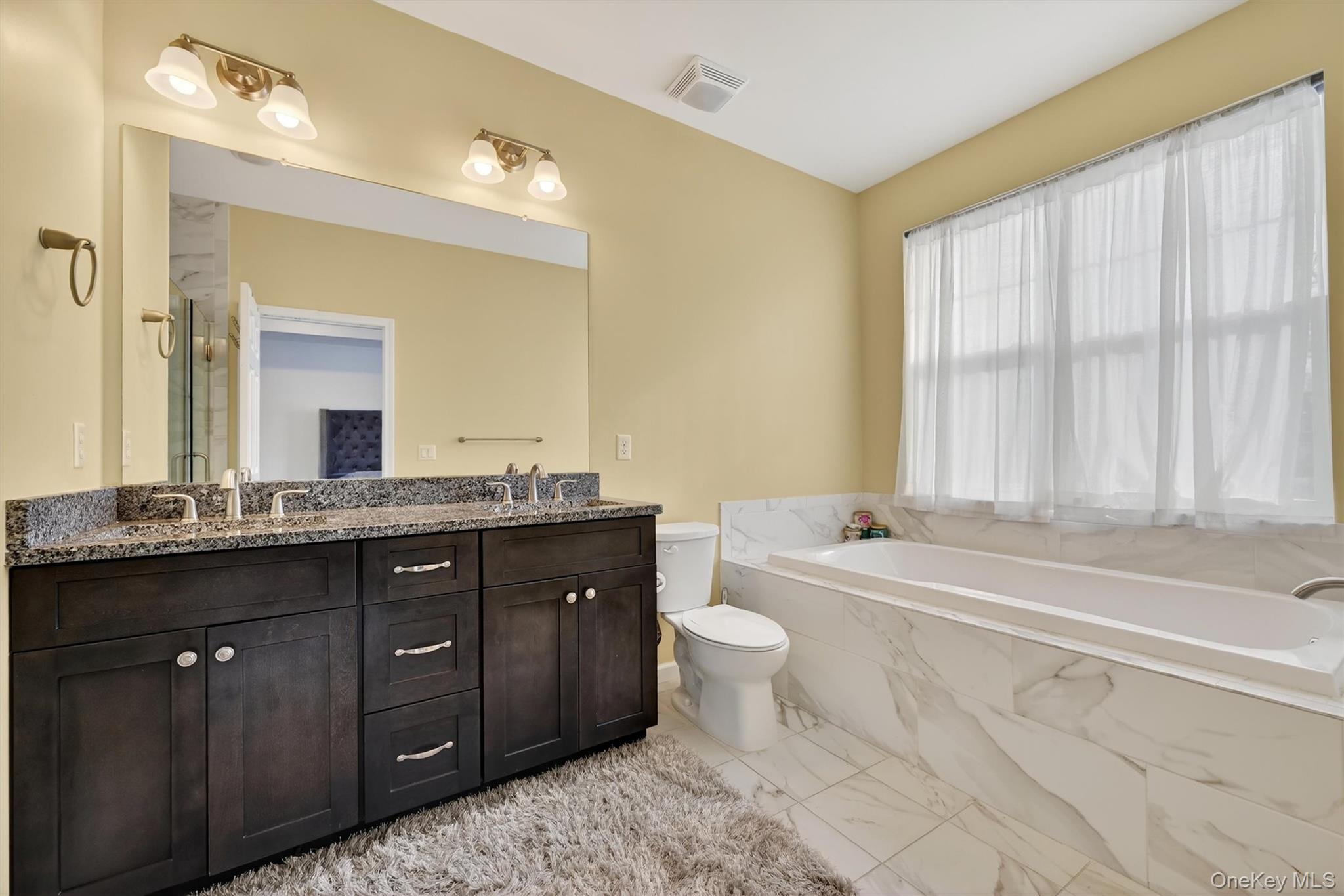 76 Magnolia Park Road Middletown, NY 10940 - Photo 23 of 39 a bathroom with a granite countertop sink and a bathtub