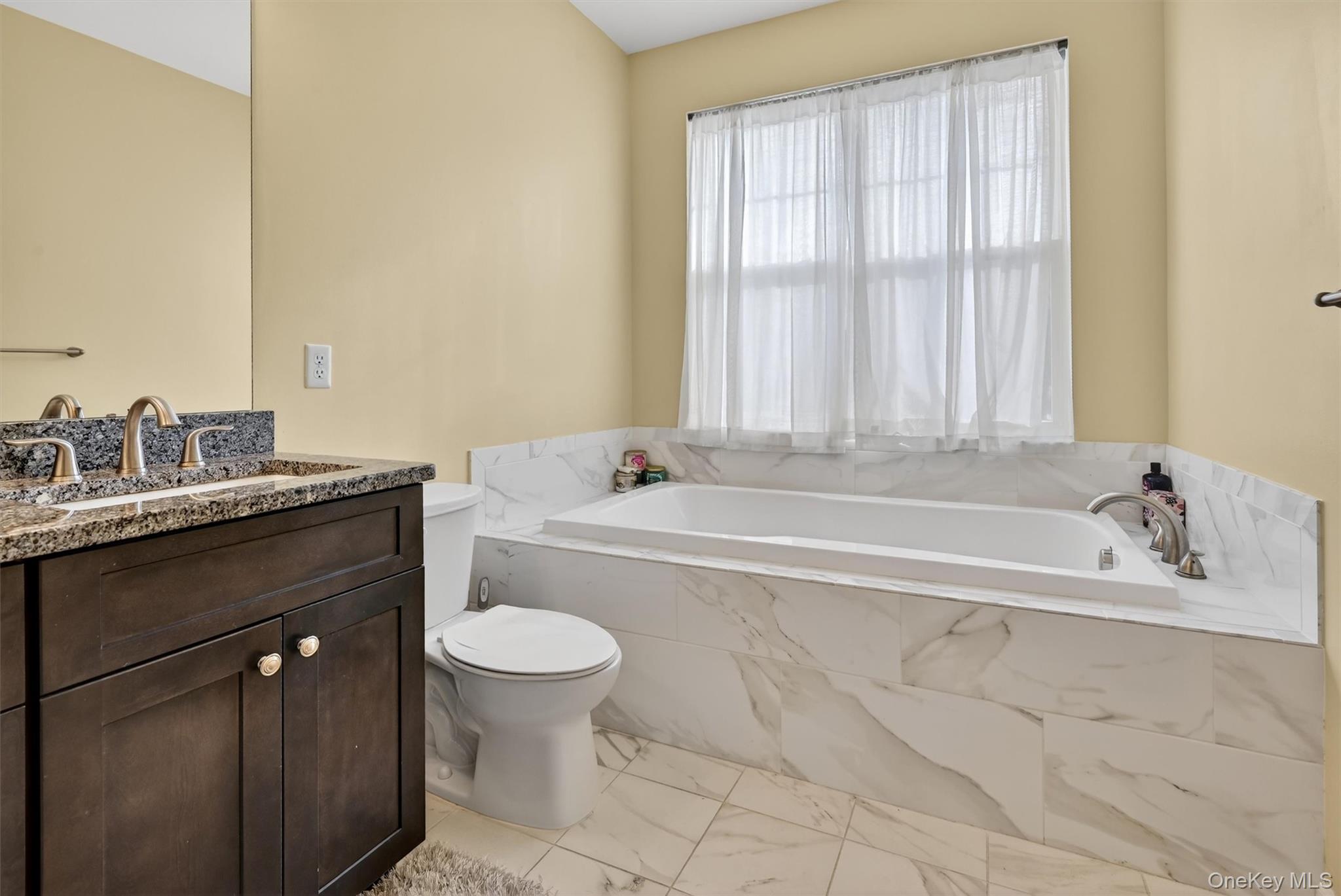 76 Magnolia Park Road Middletown, NY 10940 - Photo 24 of 39 a bathroom with a granite countertop bathtub sink vanity mirror and toilet