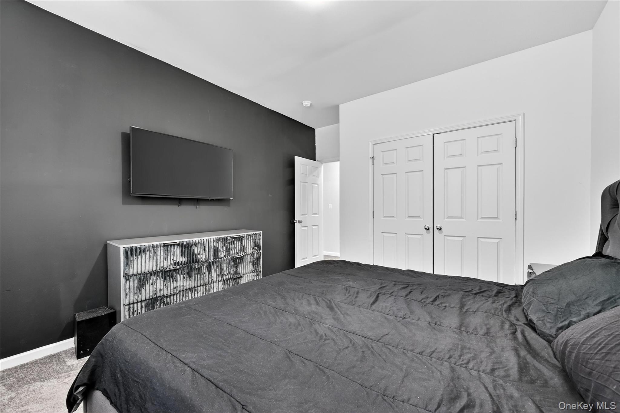 76 Magnolia Park Road Middletown, NY 10940 - Photo 26 of 39 a bedroom with a bed and a flat screen tv