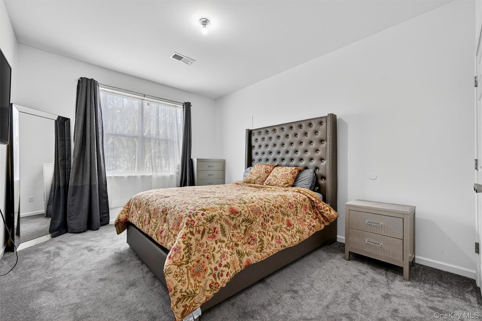 76 Magnolia Park Road Middletown, NY 10940 - Photo 27 of 39 a bedroom with a bed lamp and a large window