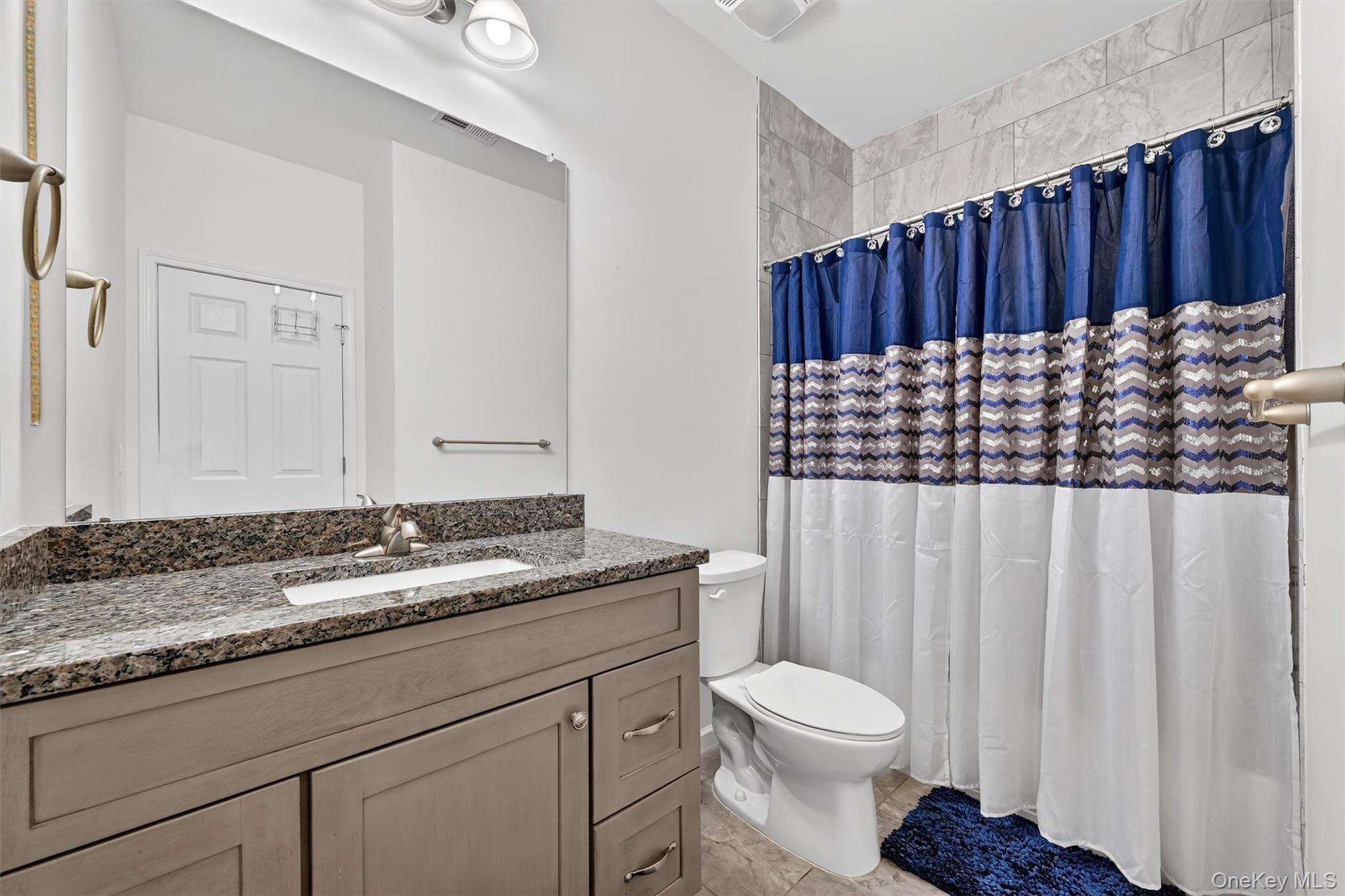 76 Magnolia Park Road Middletown, NY 10940 - Photo 29 of 39 a bathroom with a granite countertop sink and a toilet