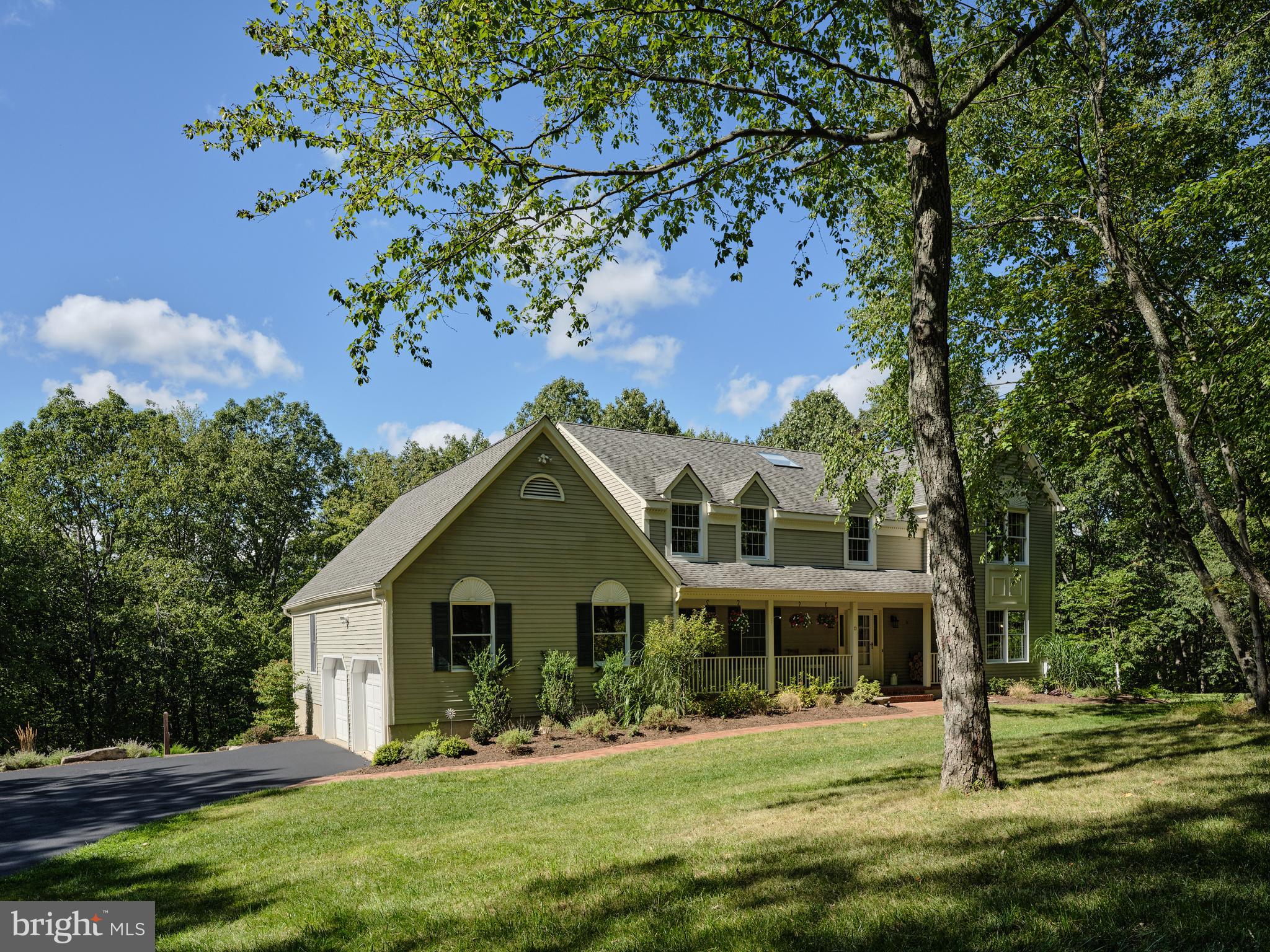 a front view of house with a garden